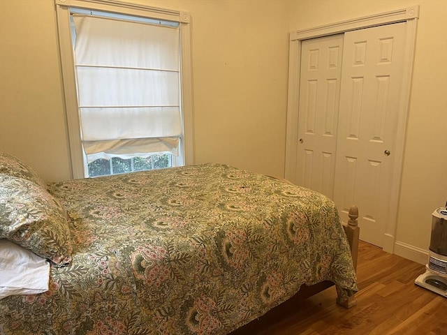 bedroom with hardwood / wood-style flooring and a closet