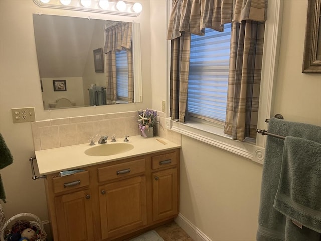 bathroom with tasteful backsplash and vanity