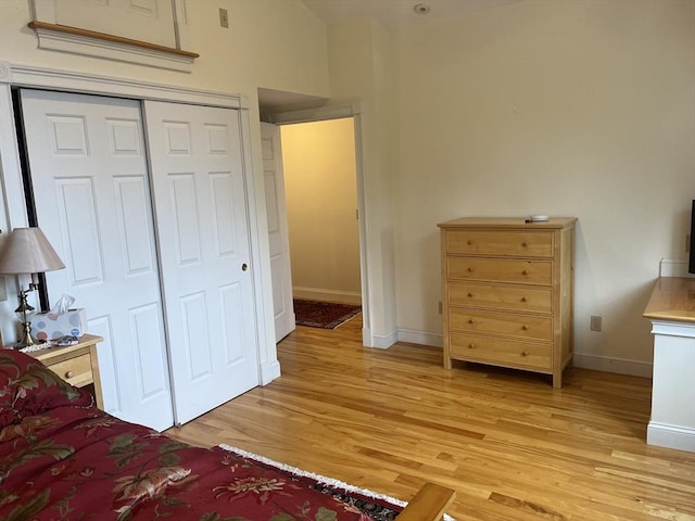 unfurnished bedroom featuring a closet and light hardwood / wood-style flooring