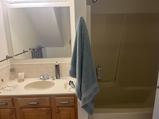 bathroom featuring tasteful backsplash and vanity