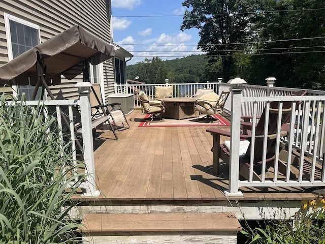 wooden terrace with an outdoor fire pit