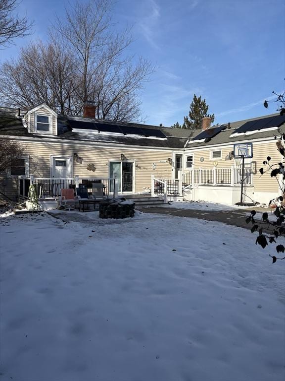 snow covered property featuring a wooden deck