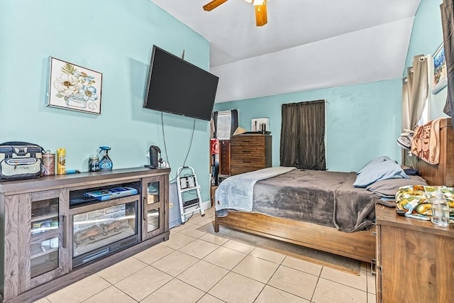 bedroom featuring lofted ceiling, ceiling fan, and light tile patterned flooring