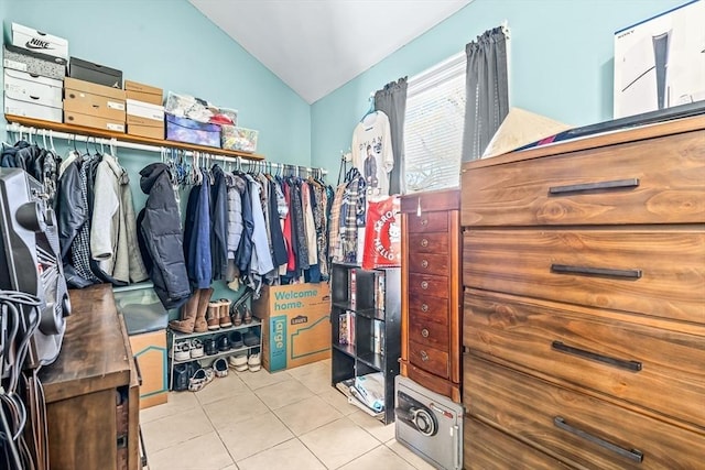 spacious closet featuring light tile patterned floors and vaulted ceiling