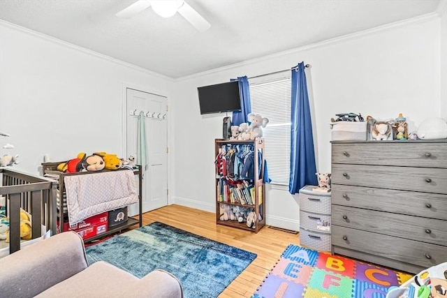 bedroom featuring ornamental molding, ceiling fan, and light hardwood / wood-style floors