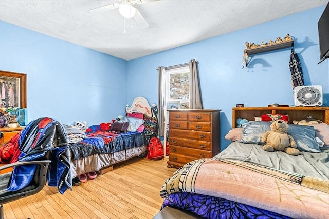 bedroom with ceiling fan and light wood-type flooring