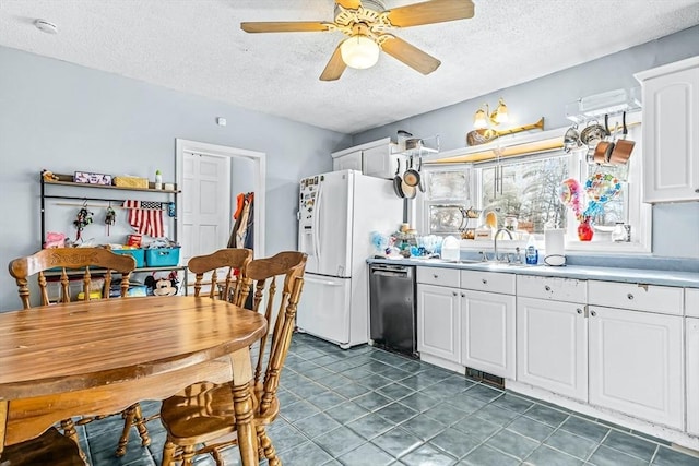 kitchen with white cabinetry, ceiling fan, white refrigerator with ice dispenser, and dishwasher