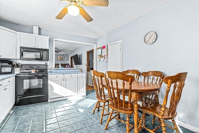 kitchen with tile patterned floors, white cabinets, ceiling fan, and black appliances