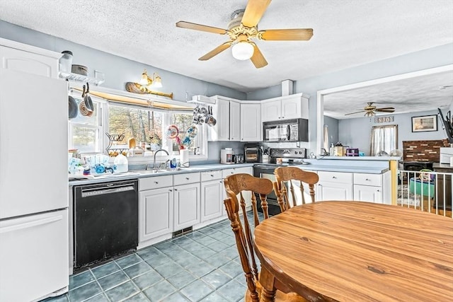 kitchen featuring sink, black appliances, a textured ceiling, ceiling fan, and white cabinets