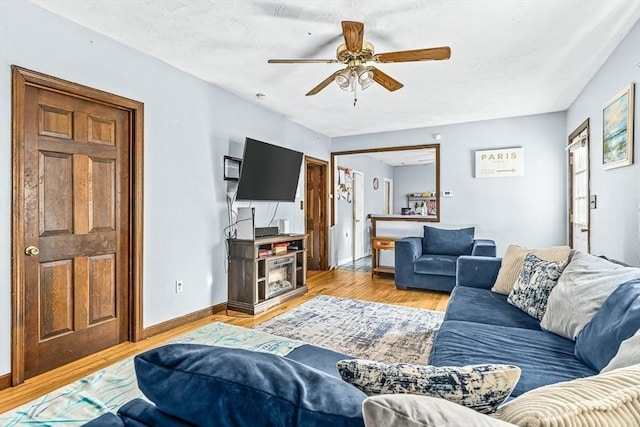 living room featuring ceiling fan and light wood-type flooring