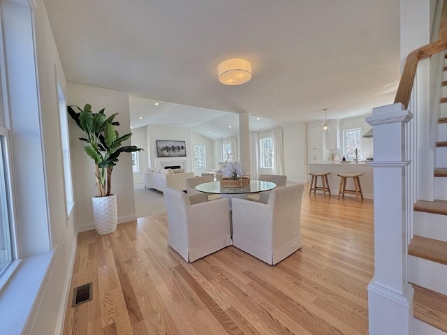 dining area featuring sink and light hardwood / wood-style flooring