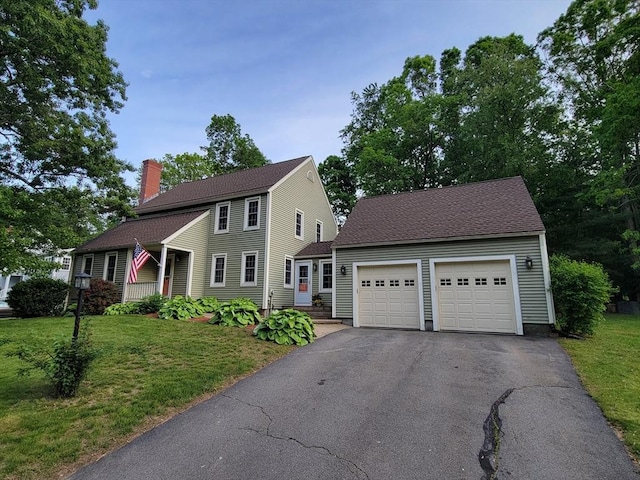18 Oakwind Holw, Leominster, MA 01453 - colonial home featuring a chimney, driveway, a front lawn, and an attached garage