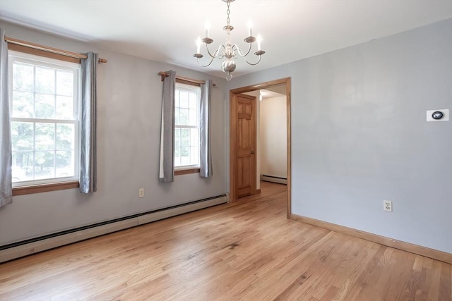 18 Oakwind Holw, Leominster, MA 01453 - empty room with a chandelier, a baseboard radiator, light wood finished floors, and baseboards