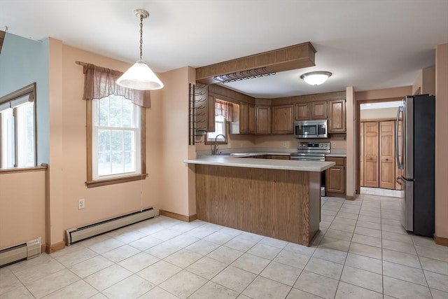18 Oakwind Holw, Leominster, MA 01453 - kitchen featuring appliances with stainless steel finishes, a baseboard radiator, a peninsula, and light countertops