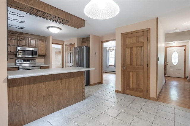 18 Oakwind Holw, Leominster, MA 01453 - kitchen with appliances with stainless steel finishes, light countertops, a peninsula, and light tile patterned floors
