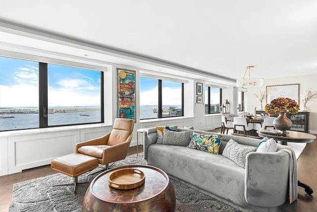 65 E India Row Unit 28Ef, Boston, MA 02110 - living area featuring a chandelier, wood finished floors, a decorative wall, and wainscoting