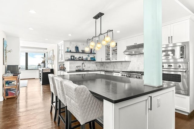 65 E India Row Unit 28Ef, Boston, MA 02110 - kitchen with stainless steel appliances, dark countertops, open shelves, backsplash, and white cabinets