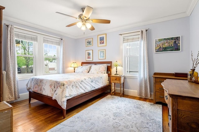 34 Sheafe St Unit 1, Brookline, MA 02467 - bedroom featuring baseboards, wood finished floors, crown molding, and ceiling fan