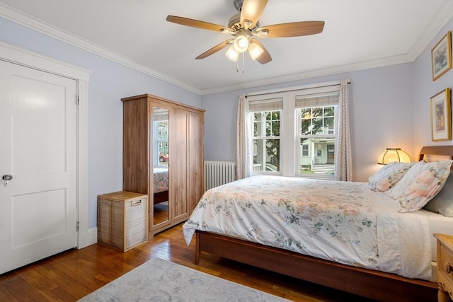 34 Sheafe St Unit 1, Brookline, MA 02467 - bedroom with wood-type flooring, ornamental molding, a ceiling fan, and baseboards