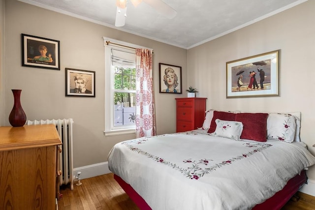 34 Sheafe St Unit 1, Brookline, MA 02467 - bedroom with hardwood / wood-style flooring, radiator heating unit, ornamental molding, baseboards, and a ceiling fan