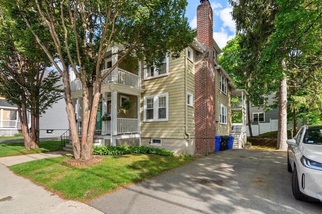 34 Sheafe St Unit 1, Brookline, MA 02467 - view of front of home featuring a balcony, a chimney, a porch, and a front yard