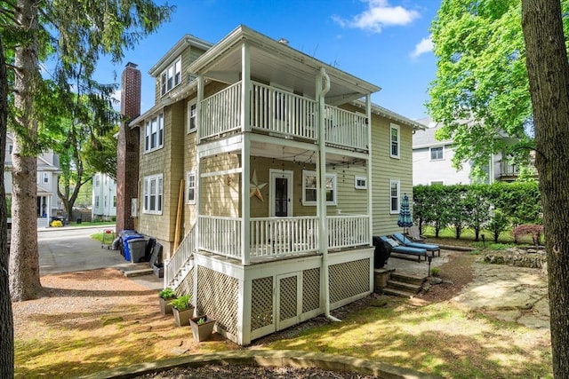 34 Sheafe St Unit 1, Brookline, MA 02467 - back of property featuring a balcony, a chimney, and stairway