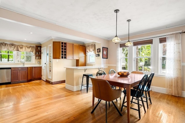 34 Sheafe St Unit 1, Brookline, MA 02467 - dining area with baseboards, light wood finished floors, and ornamental molding