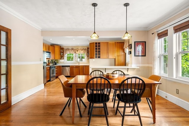 34 Sheafe St Unit 1, Brookline, MA 02467 - dining space with baseboards, ornamental molding, and light wood-style floors