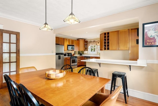 34 Sheafe St Unit 1, Brookline, MA 02467 - dining space featuring light wood-type flooring, baseboards, ornamental molding, and recessed lighting