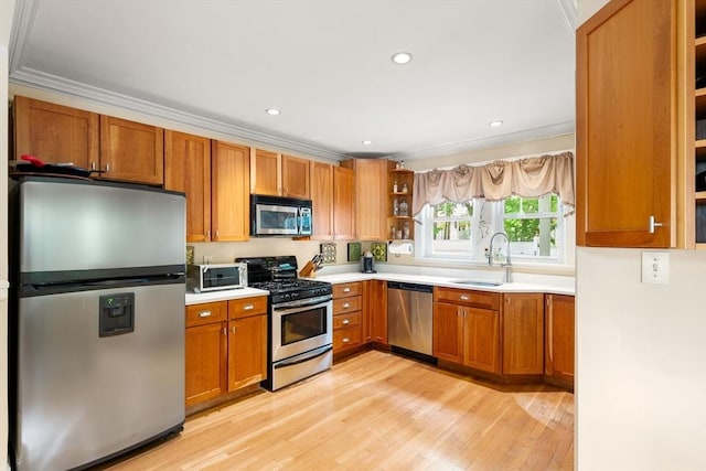 34 Sheafe St Unit 1, Brookline, MA 02467 - kitchen with stainless steel appliances, open shelves, a sink, ornamental molding, and light wood-style floors