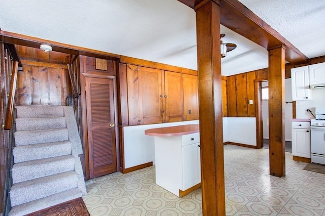 interior space with wooden walls and a textured ceiling