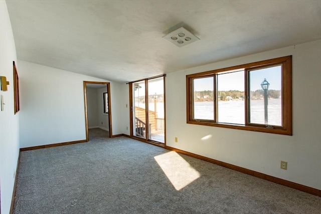 spare room with lofted ceiling and carpet floors