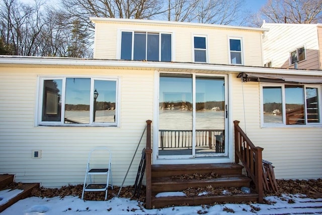 view of snow covered rear of property