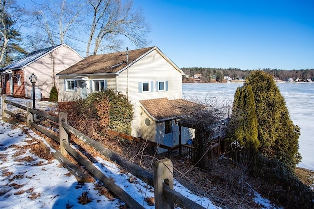 view of snow covered rear of property