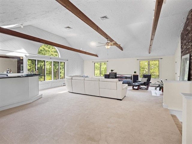 living room featuring light carpet, visible vents, and a textured ceiling