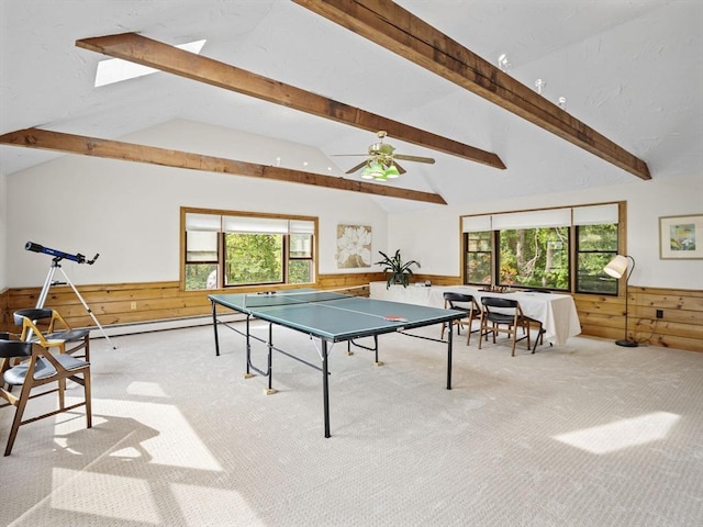 rec room with a wainscoted wall, a wealth of natural light, and light colored carpet