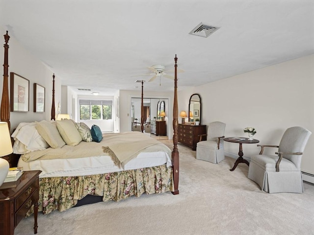 bedroom with a ceiling fan, light colored carpet, and visible vents