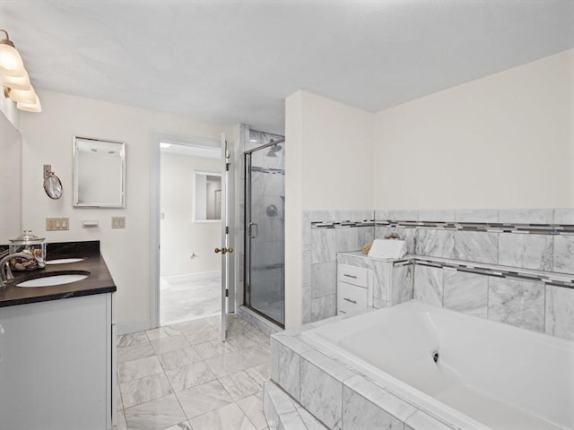 bathroom featuring a garden tub, vanity, baseboards, marble finish floor, and a stall shower