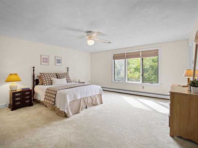 bedroom with a baseboard heating unit, light colored carpet, a textured ceiling, and a ceiling fan