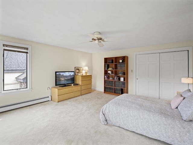 carpeted bedroom with a baseboard radiator, a ceiling fan, and a closet