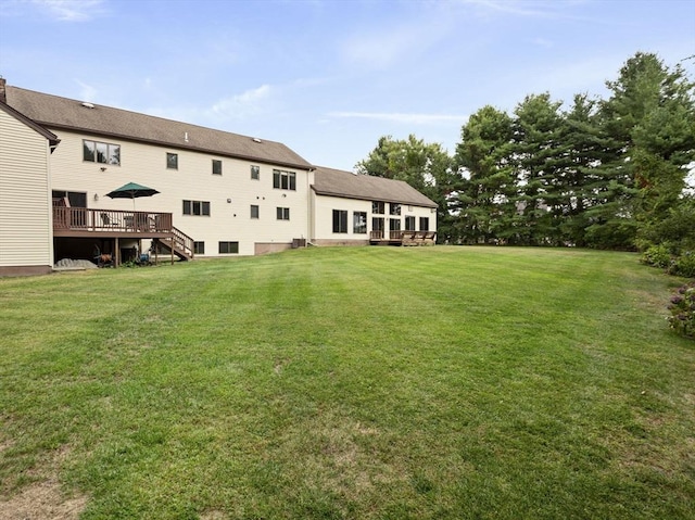 view of yard featuring stairway and a wooden deck