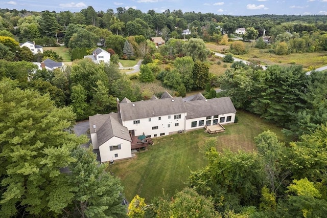 bird's eye view with a wooded view