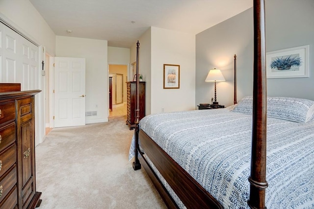 bedroom featuring light carpet, visible vents, and baseboards