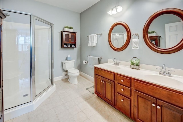 full bathroom featuring toilet, a sink, double vanity, and a stall shower