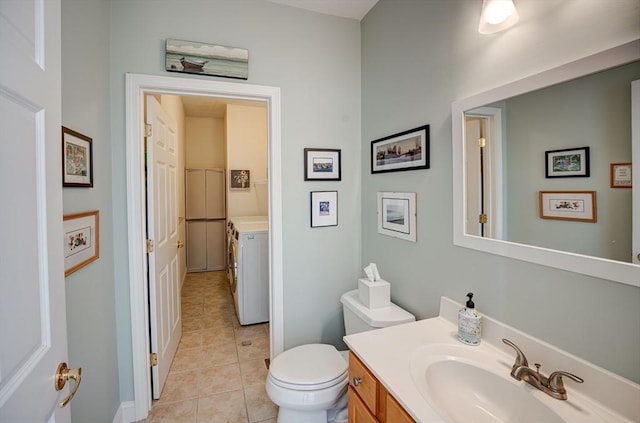 bathroom featuring vanity, washer and dryer, toilet, and tile patterned flooring