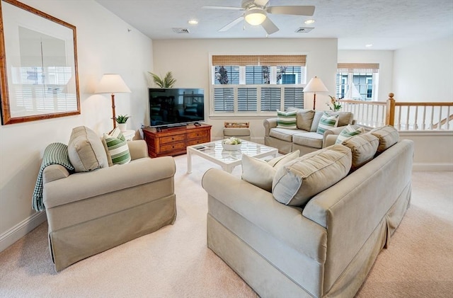 carpeted living area with visible vents, baseboards, recessed lighting, and ceiling fan