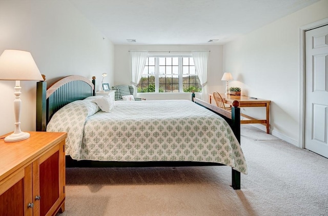 bedroom featuring visible vents and light colored carpet