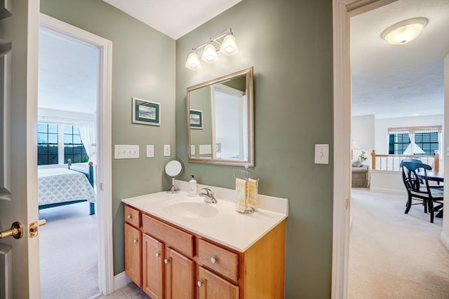 bathroom featuring baseboards and vanity