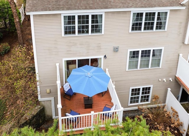back of house with a wooden deck and a shingled roof