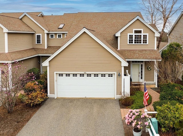 view of front of house with aphalt driveway and roof with shingles